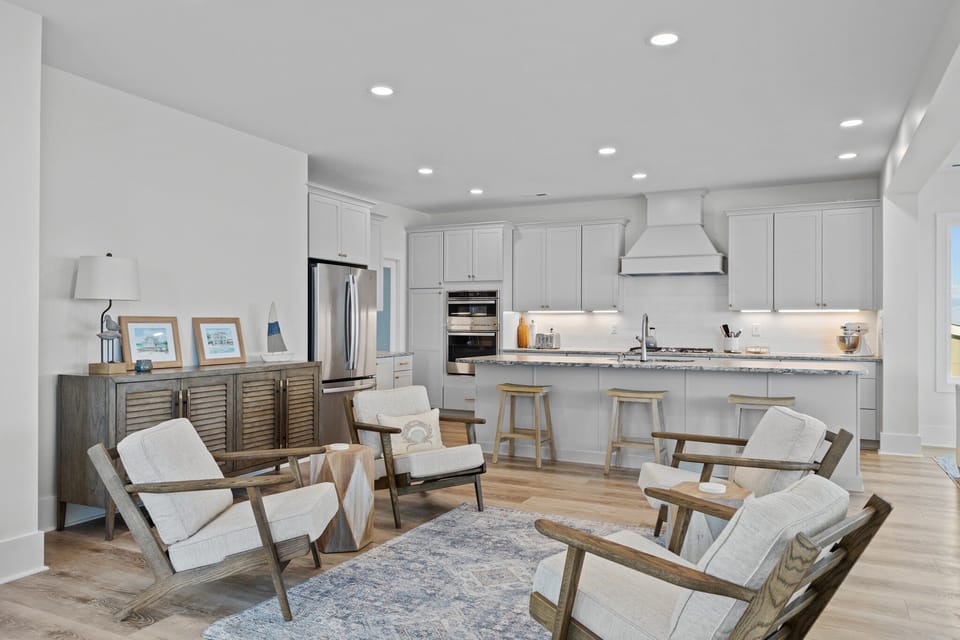 Gather with loved ones in this bright, open-concept space where modern kitchen meets cozy living area with stylish seating.