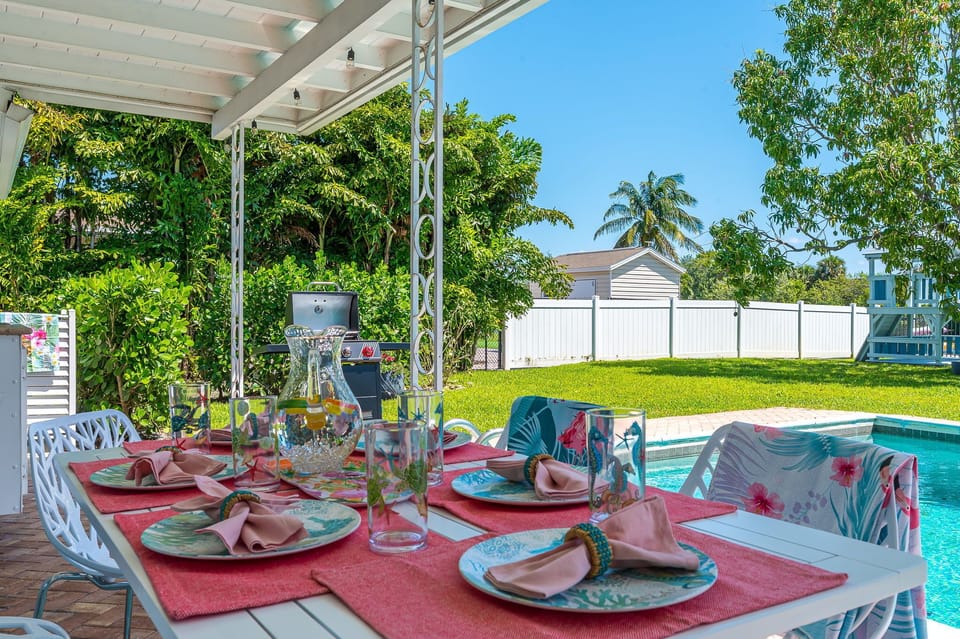 There is a lovely outdoor dining table for 6, with Birch Sapling cut-out-tree design chairs under cover, and a propane BBQ.