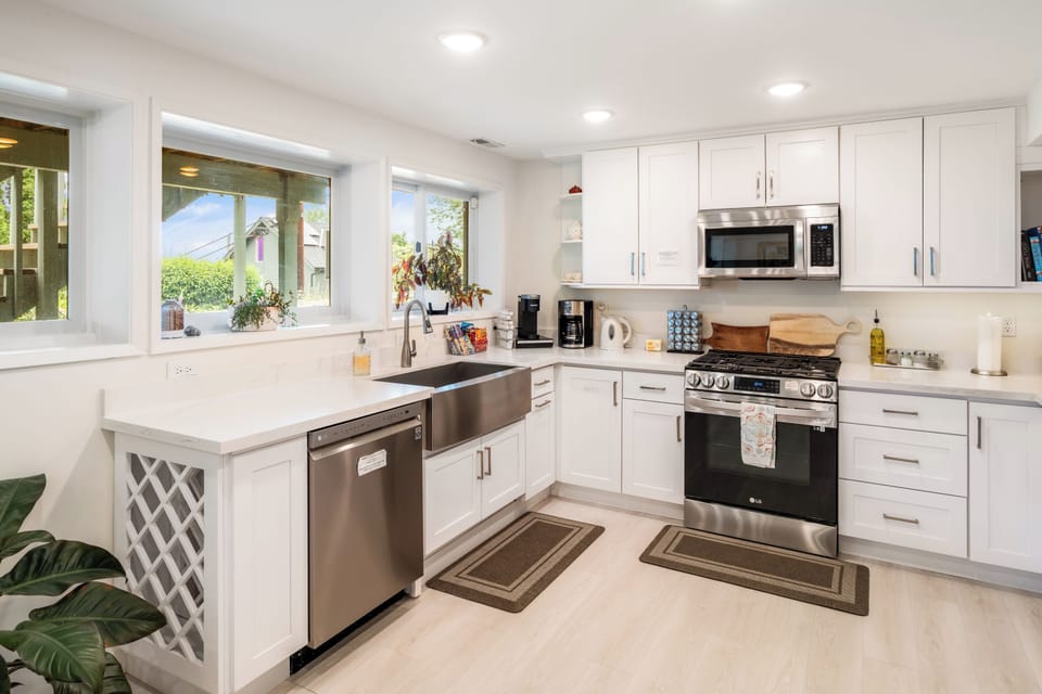 Kitchen with coffee maker, oven, stovetop, and microwave.