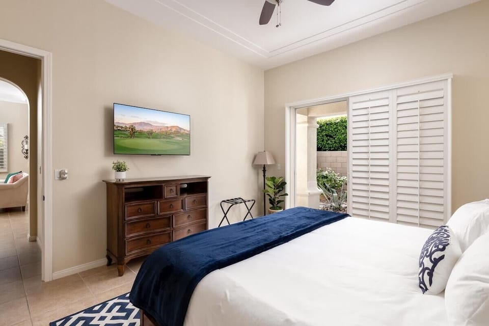 Guest bedroom with a comfortable bed and a TV.