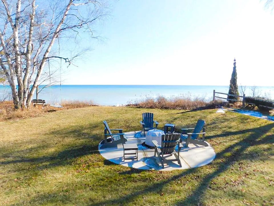Private fire pit with Adirondack seating overlooking Lake Michigan. Perfect for s’mores and sunset nights.