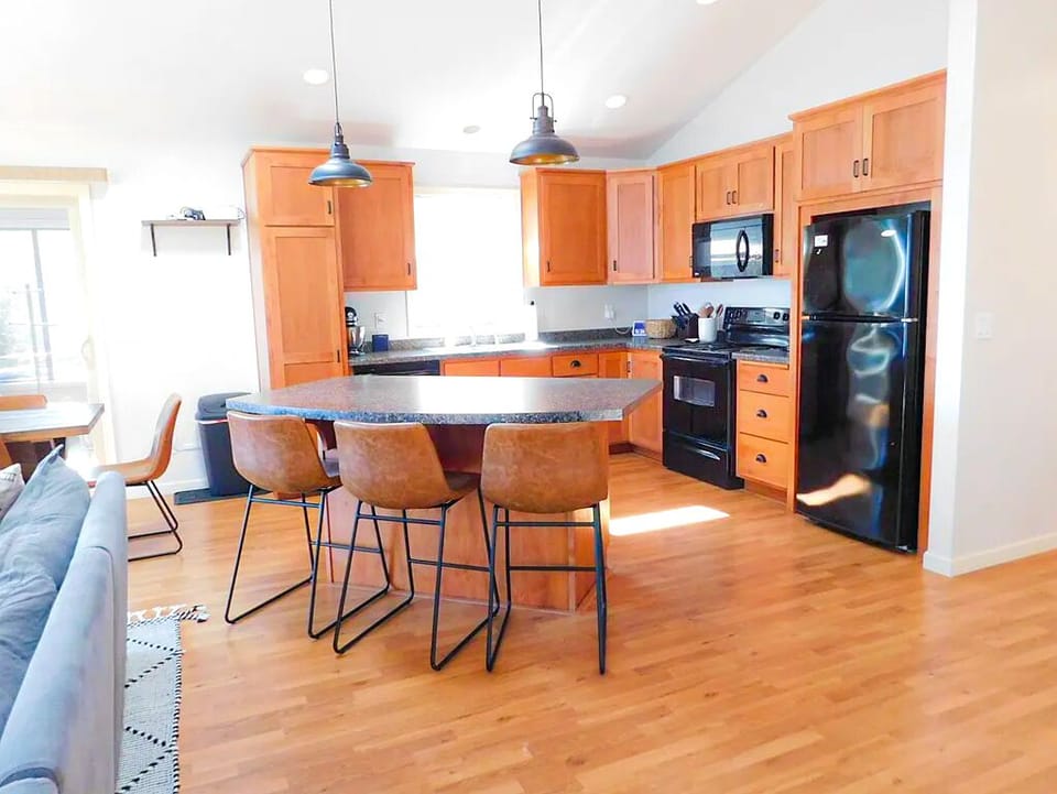 Spacious kitchen with island seating for group meals, just steps from the Lake Michigan shoreline.