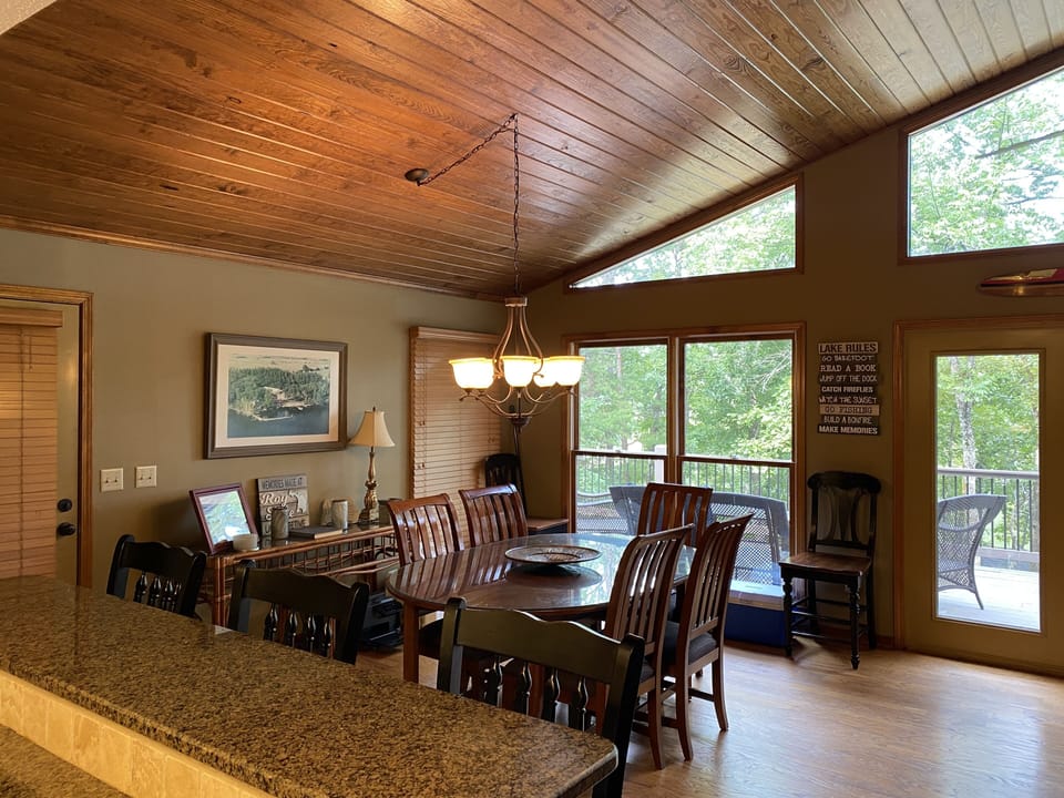 Indoor dinette set with 6 chairs, and breakfast bar with 3 stools.