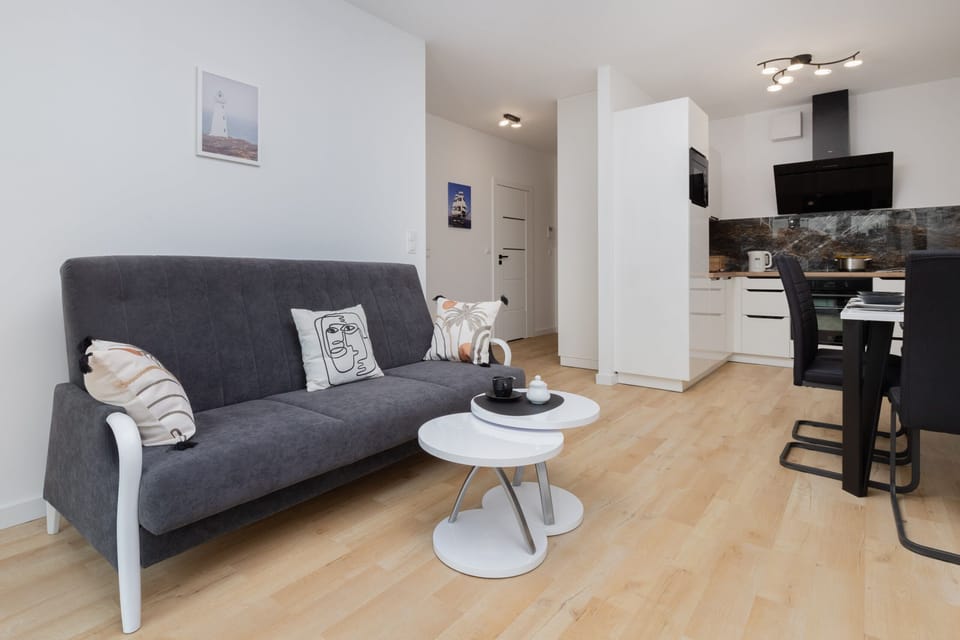 Another perspective of the living room with a focus on the sofa and decorative pillows, adding comfort and charm.
