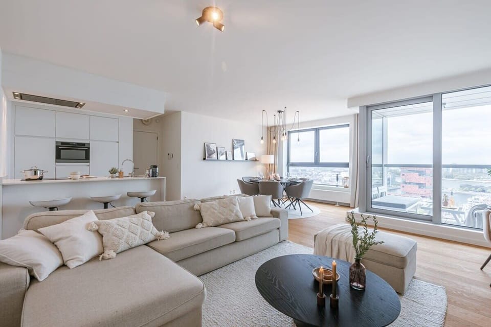 Open living room — light, comfort, and soft city rhythm.
