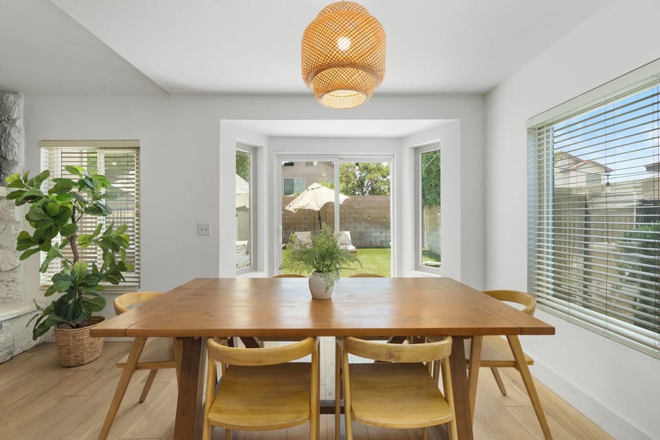 The dining table seats six Enjoy the sunny backyard view through the bay window.