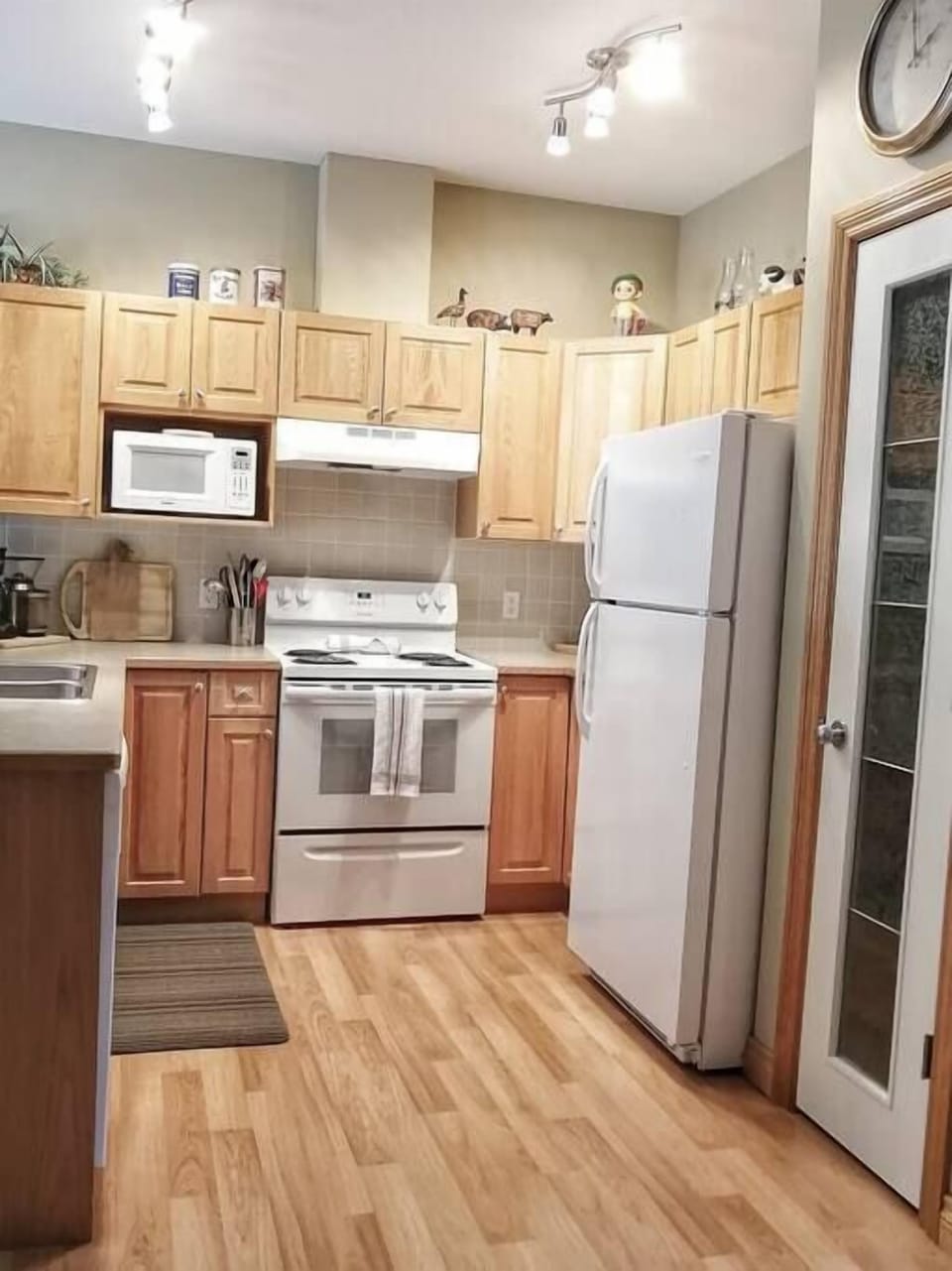 Fully equipped kitchen stocked with cookware and small appliances.