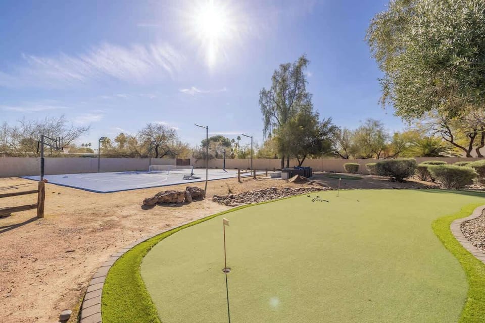 Practice your putting skills on the backyard green, ideal for casual games and relaxation.