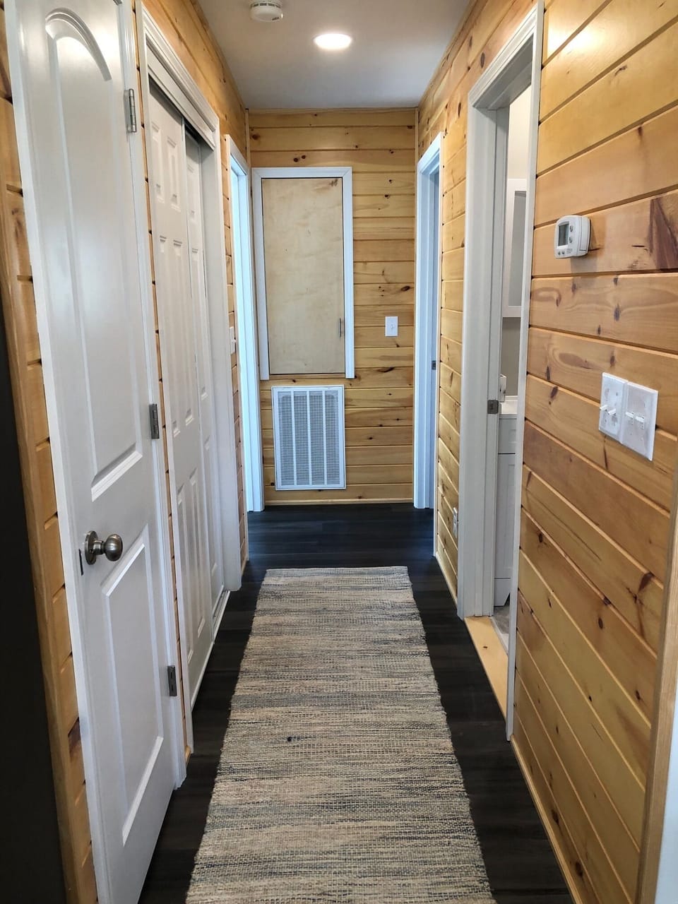Hallway with full washer and dryer