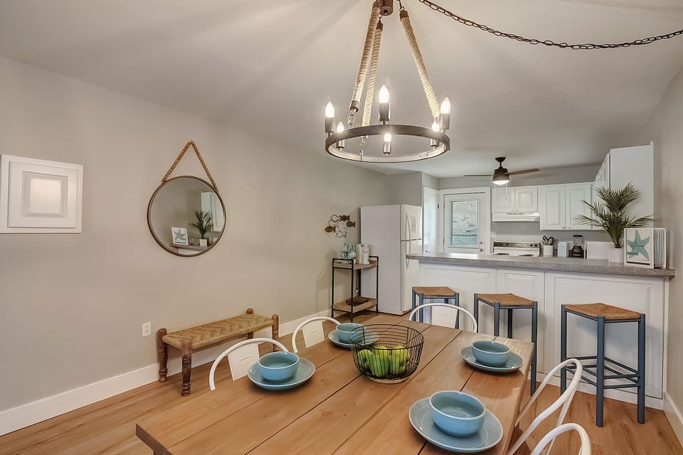Your coastal-inspired kitchen and dining area blends warmth with modern convenience, perfect for morning coffee or family meals together.