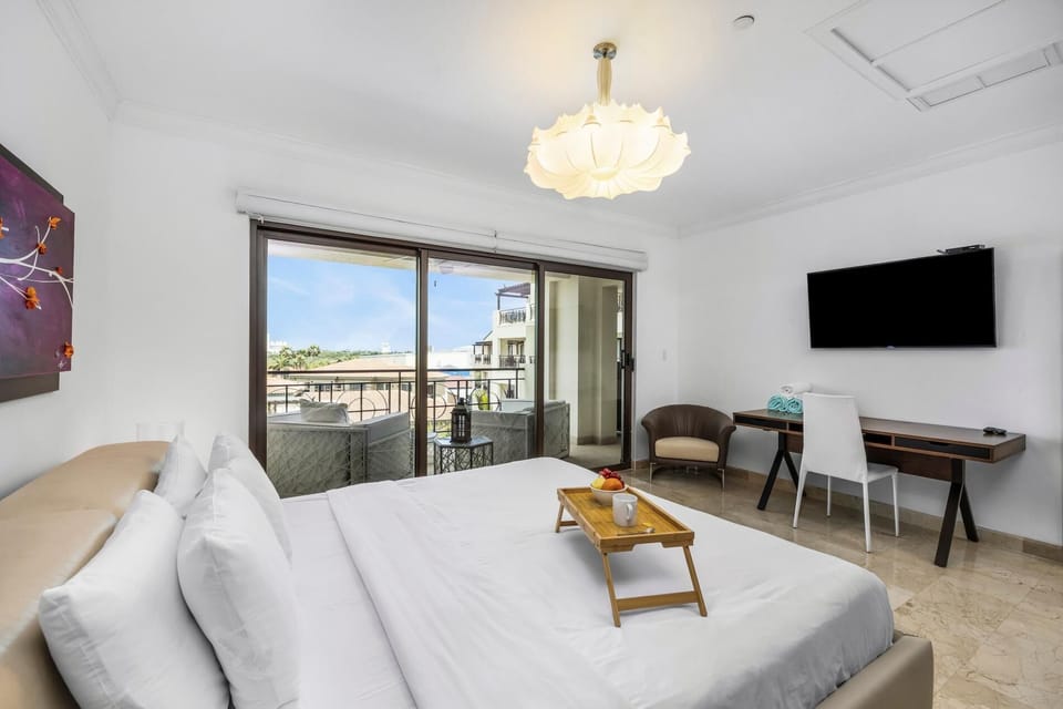 A cozy and comfy bed after a long day. With a TV to watch your favorite show with access to the balcony.