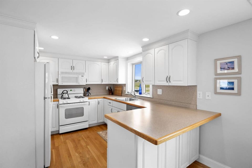 Fully equipped kitchen with microwave, coffee maker, toaster, toaster oven, tea kettle, and all the other items you need to have a summer family dinne