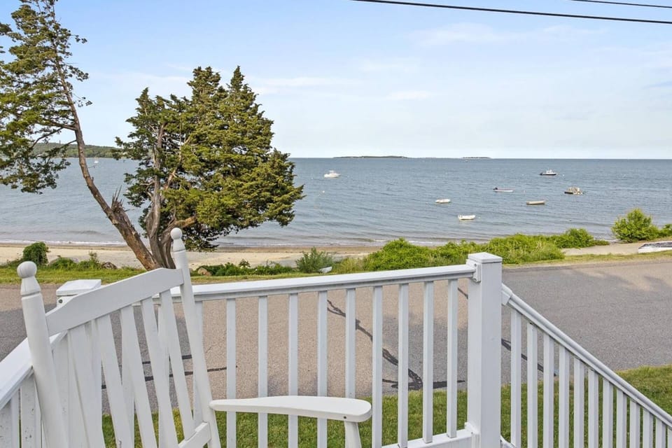 View of the beach from the front porch with outdoor furniture