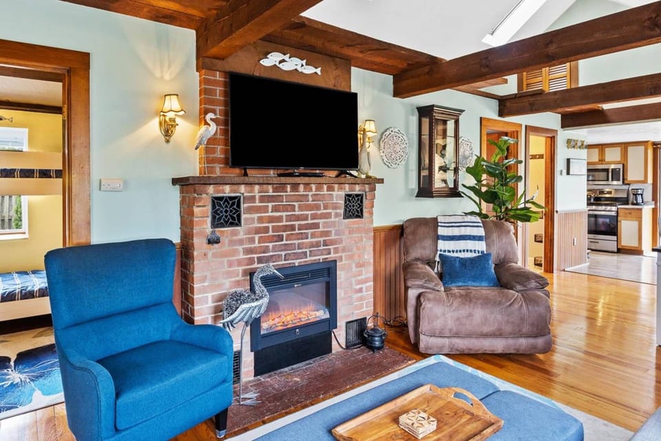 Family Room 2 of 2 with recliner, electric fireplace and smart TV on the wall and plenty of seating for the whole family. Couch also pulls out to a qu