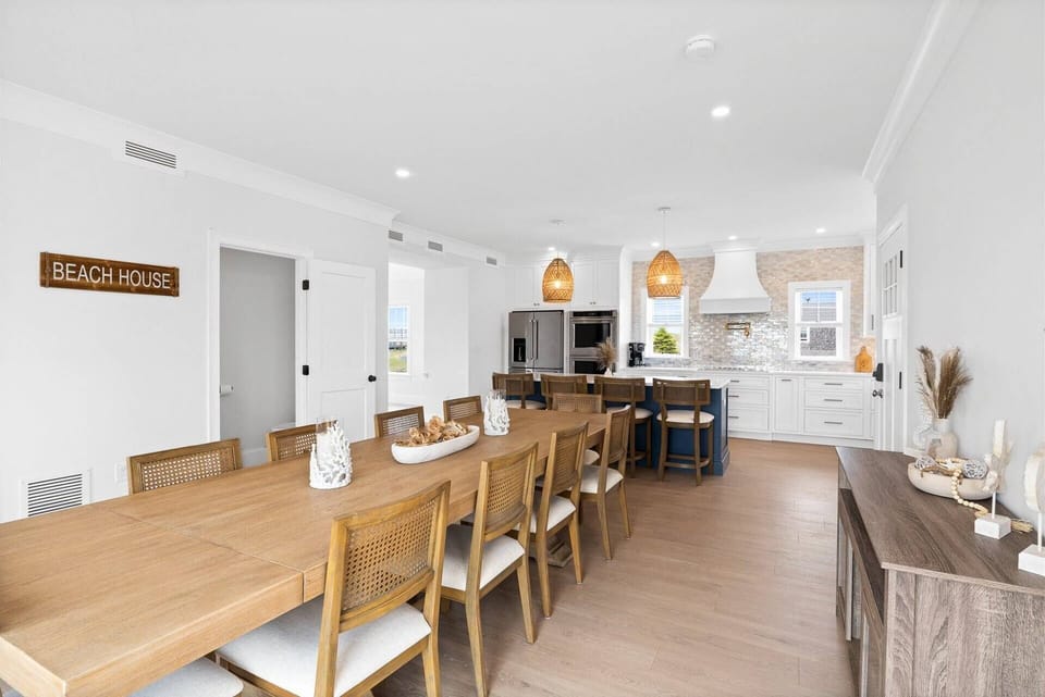 Large dining room table and modern kitchen with bar seating