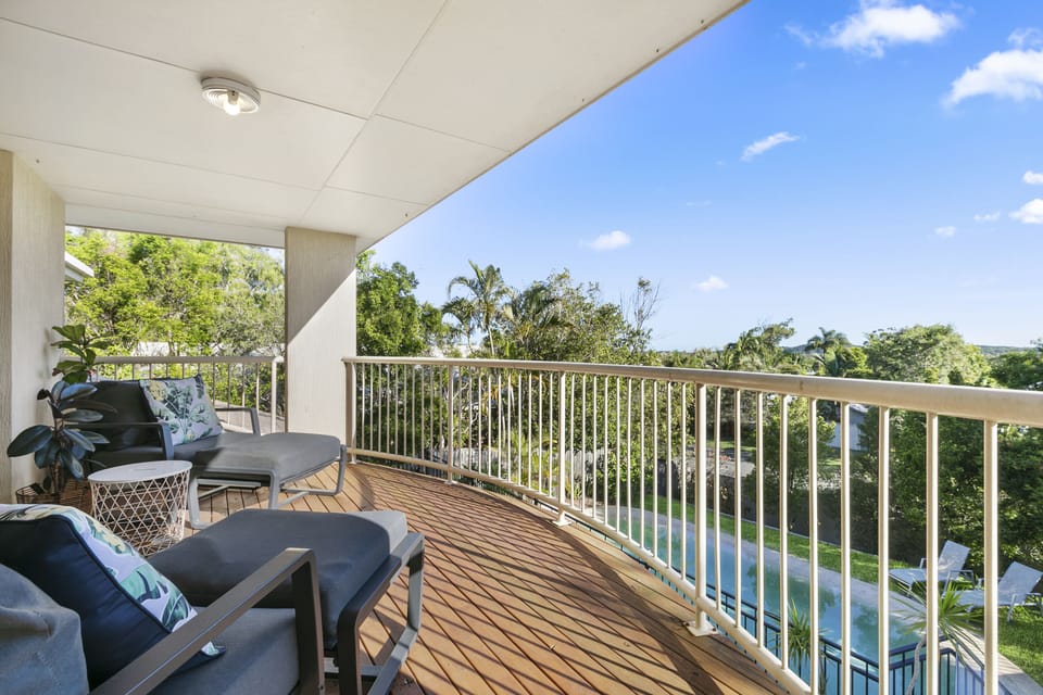 Elevated balcony with seating and views over the pool