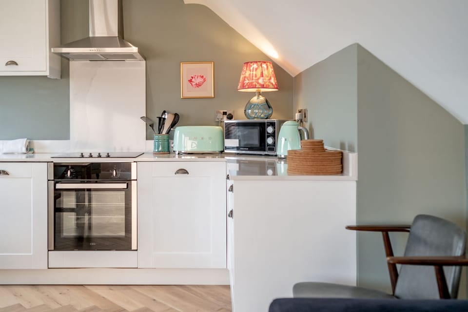 Fully equipped kitchen with oven, hob,  microwave, dishwasher, kettle & toaster.