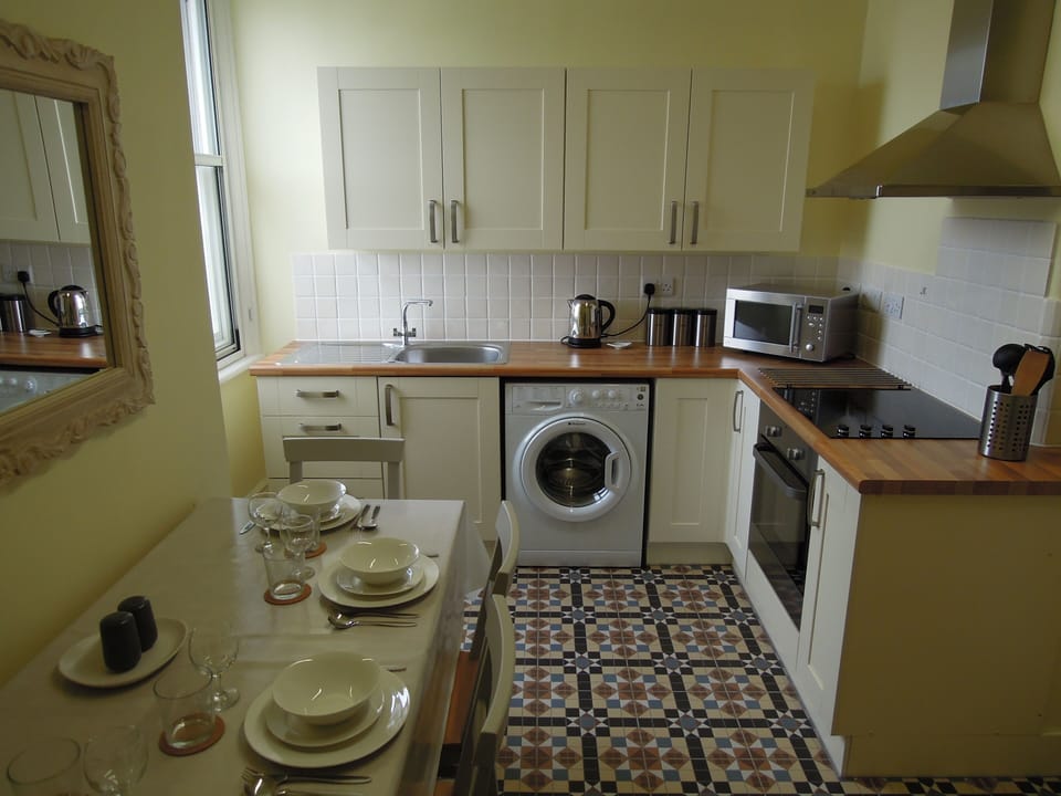 Large fully equipped kitchen with dining table and chairs