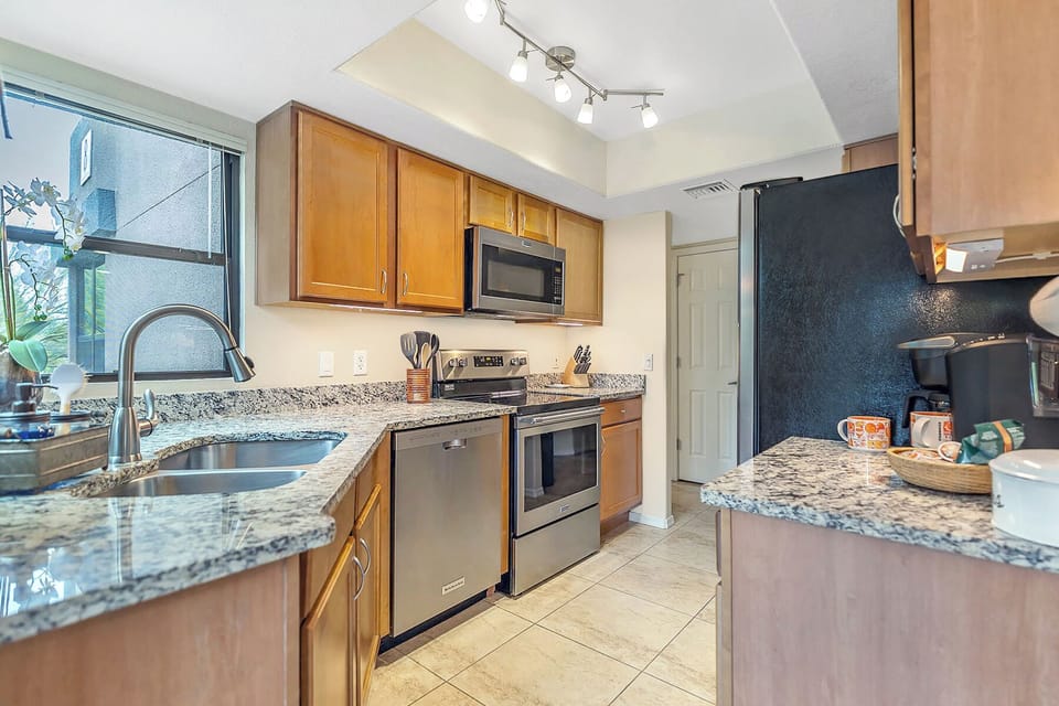 Enjoy a modern and functional kitchen featuring updated granite countertops and stainless steel appliances. Prepare delicious meals with ease and style.