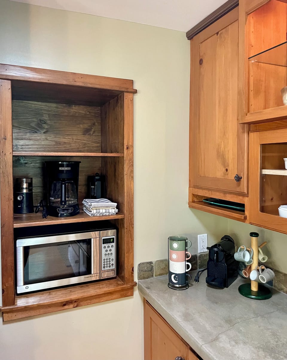 Coffee grinder, traditional drip coffee brewer, french press, and Nespresso. 