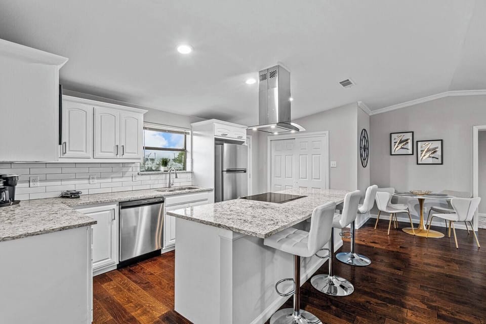 Bar stools provide additional seating around the breakfast bar or island, fostering a social and inviting atmosphere.