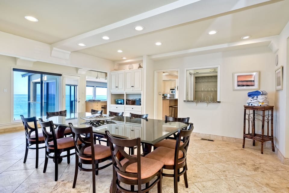 Back inside we find the dining area connecting to a sun room and kitchen