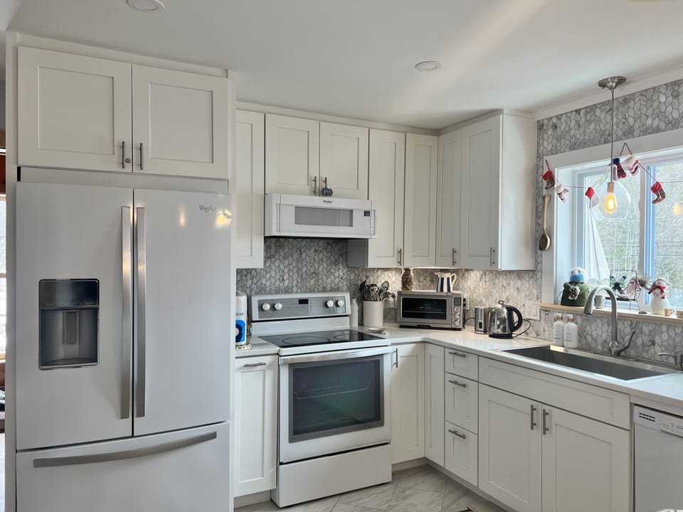 Main floor kitchen with pots,pans, dishes, spices. Ready for a delish meal. 