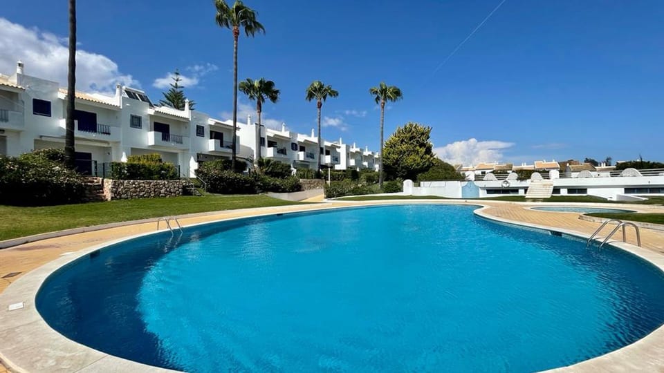 Dive into the sparkling blue waters of the communal pool, surrounded by swaying palms under a clear sky.
#SwimmingPool #OutdoorLiving #LovelyStay