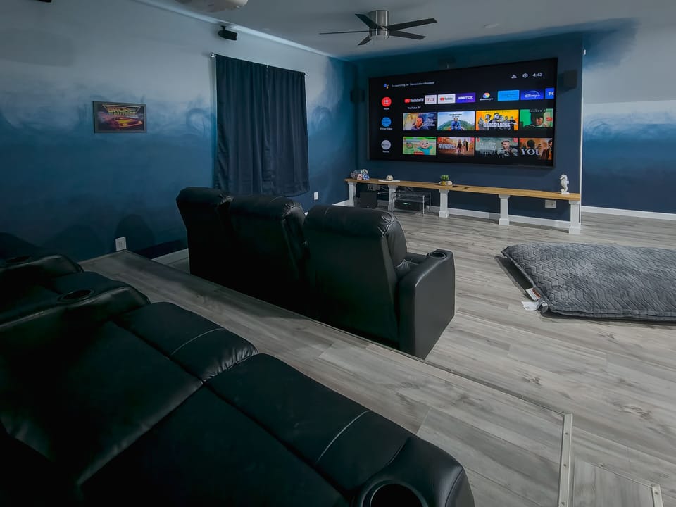 135" 4K Ultra HD Home Cinema. Luxurious recliner armchairs for movie nights.