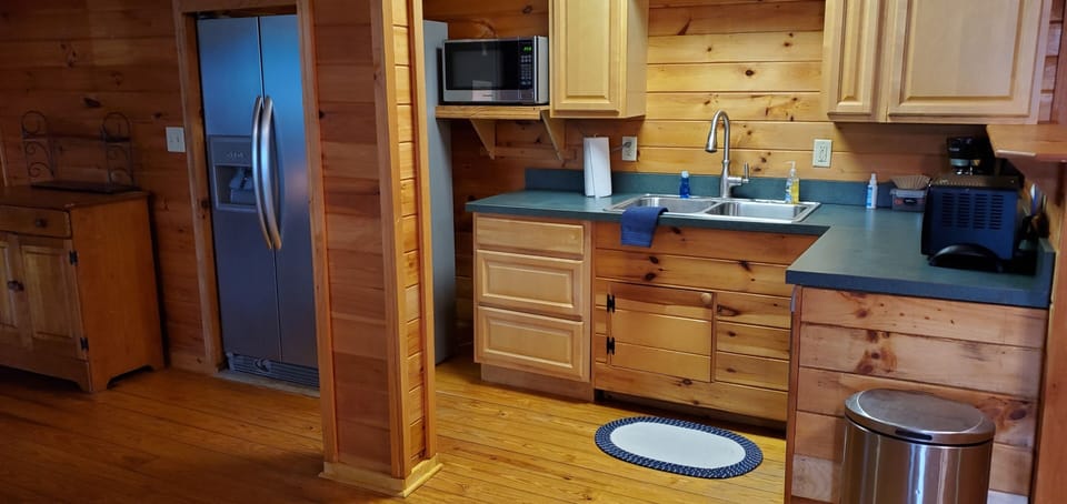 kitchen in basement, fridge, dishwasher, microwave,  coffee pot, toaster oven