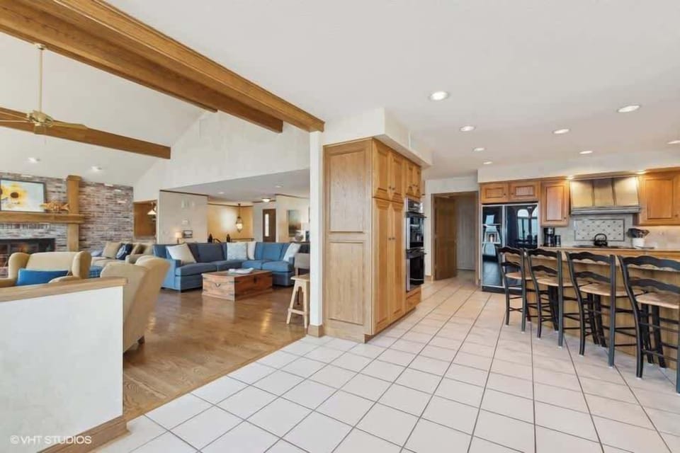 Large gathering Kitchen with bar and dining area with an open floor plan and connected to the living room. 