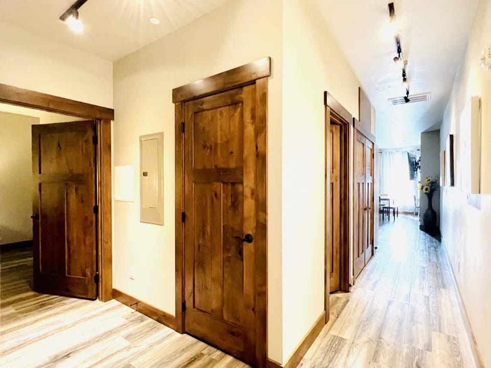 Hallway to primary bedroom, guest bedroom and then living area