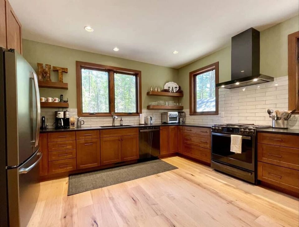 Large open kitchen with gas range and new stainless appliances
