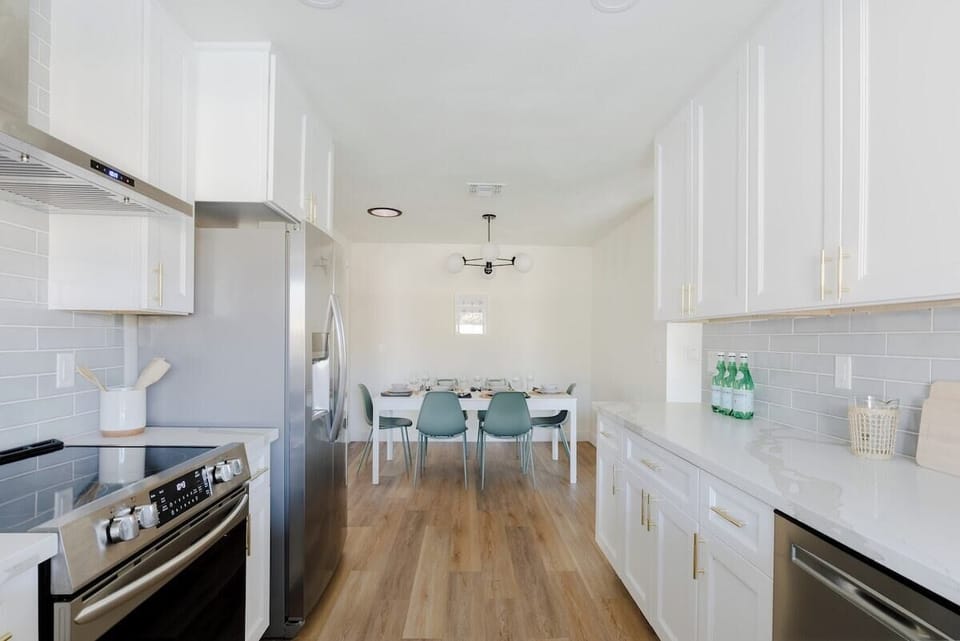 Heart of the Home! Make some tasty, heartfelt meals for those you love in this fully-equipped white kitchen. Instacart and Doordash both deliver to this address. Also Whole Foods, Trader Joes and Costco all located nearby.