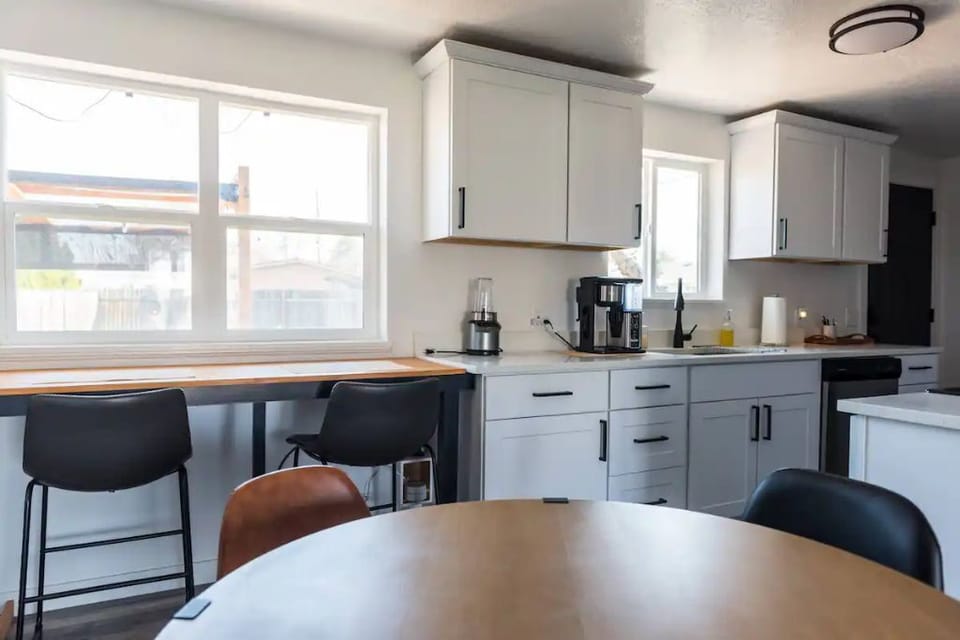 Looking at the bar and kitchen from the 4-top dining table. 