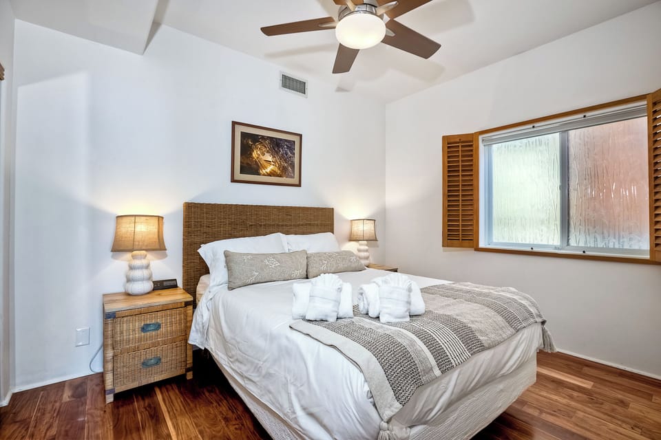 Second bedroom with ceiling fan and a comfortable bed
