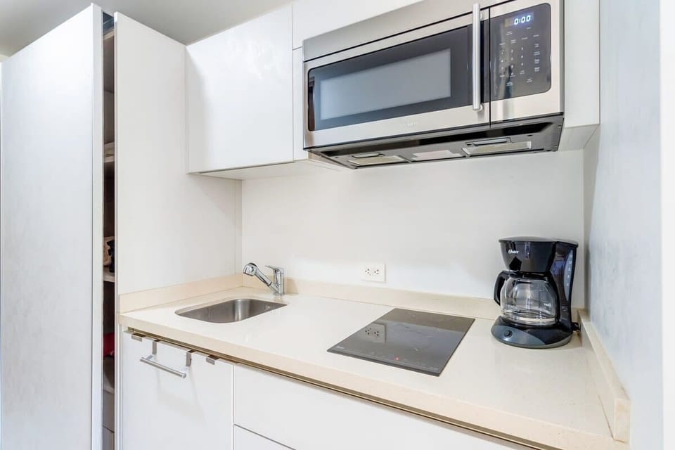Kitchenette ready for light cooking or reheating meals.