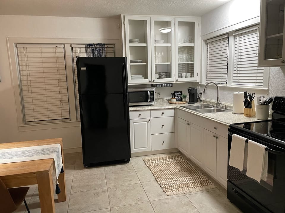 Full-size kitchen with refrigerator, microwave and stove.
