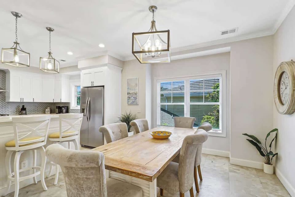 Gather around your elegant dining table where warm wood meets soft textures, creating the perfect space for memorable meals together.