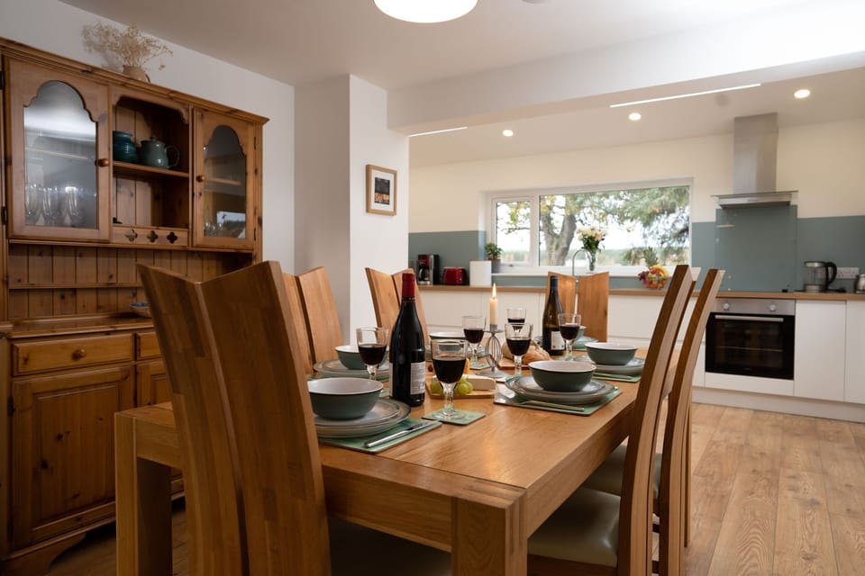 Rivercroft table set for dinner with kitchen behind