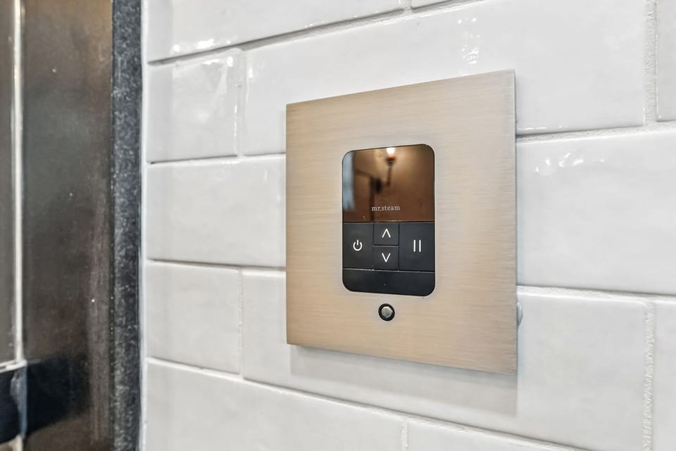 Wall-mounted Mr. Steam digital steam shower control.