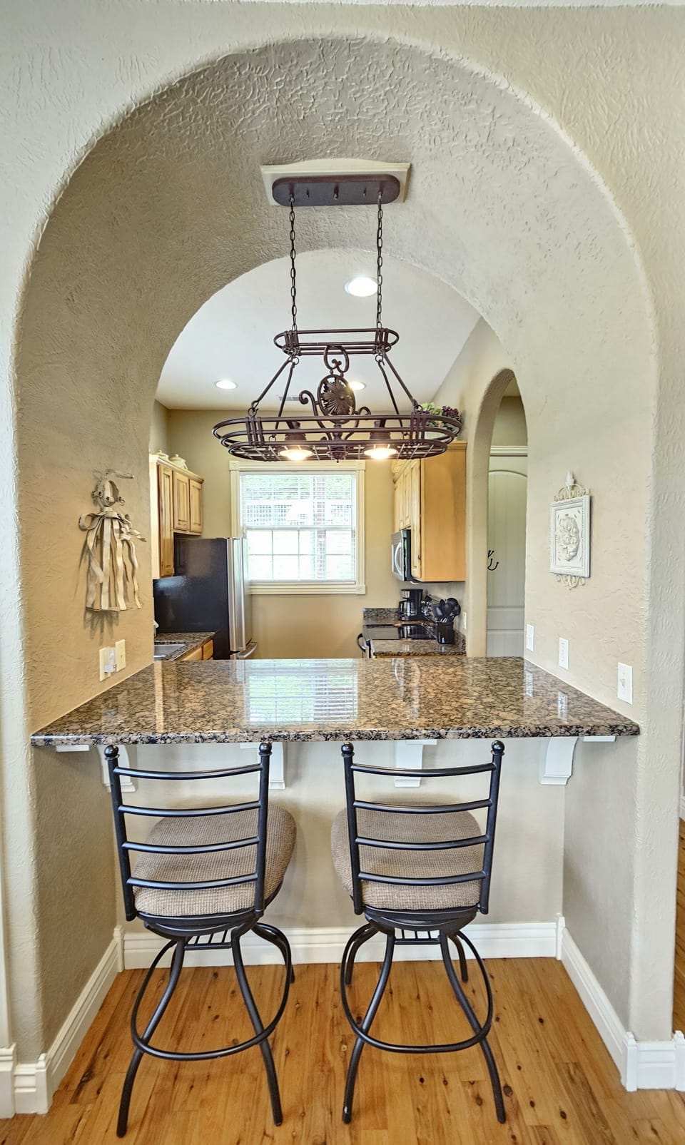 Breakfast bar, tall chairs, gorgeous lighting and decor!