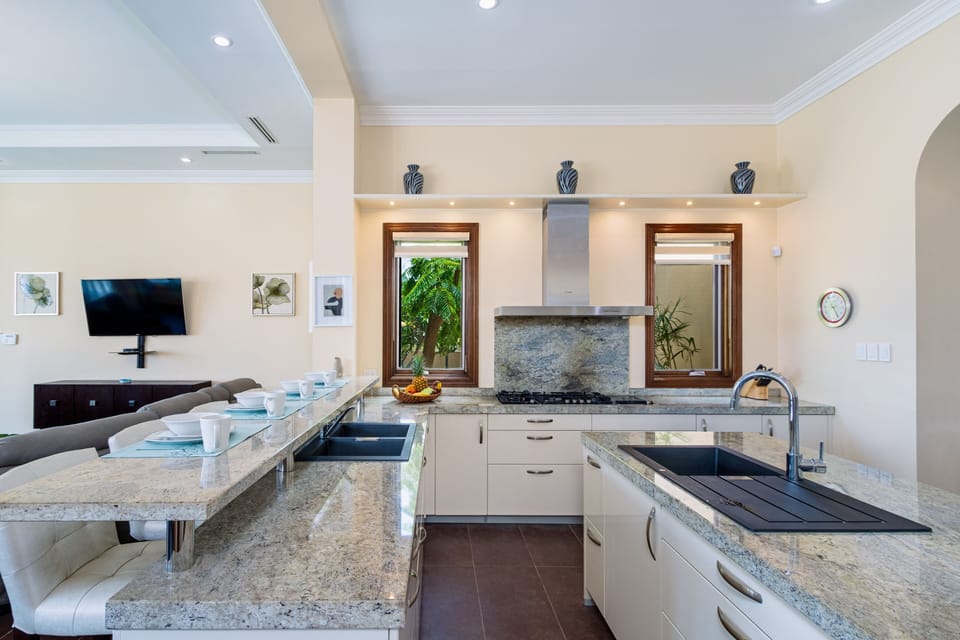 Elevate your culinary experience in our sleek, fully equipped kitchen with stainless steel appliances, perfect for preparing gourmet meals or quick snacks with ease.