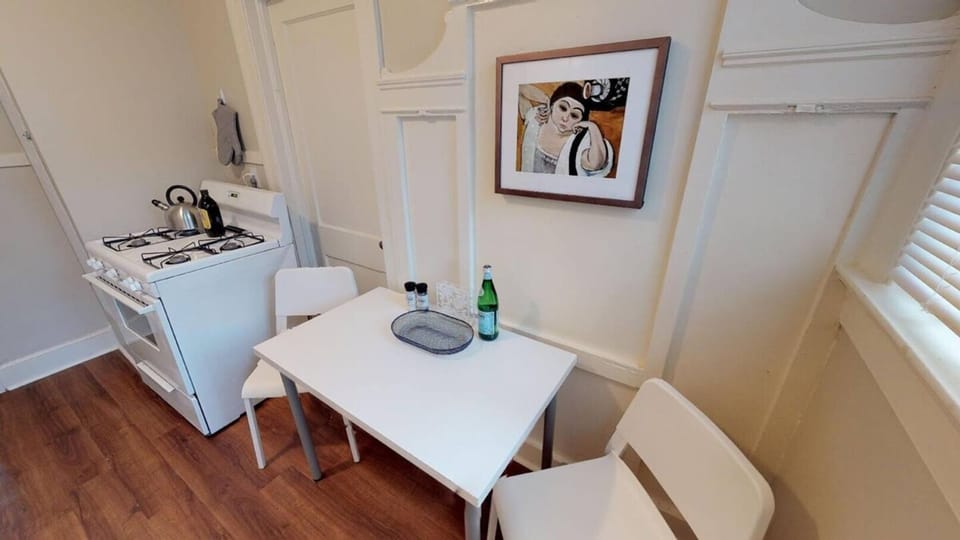 Kitchen with small table for eating or computer work.