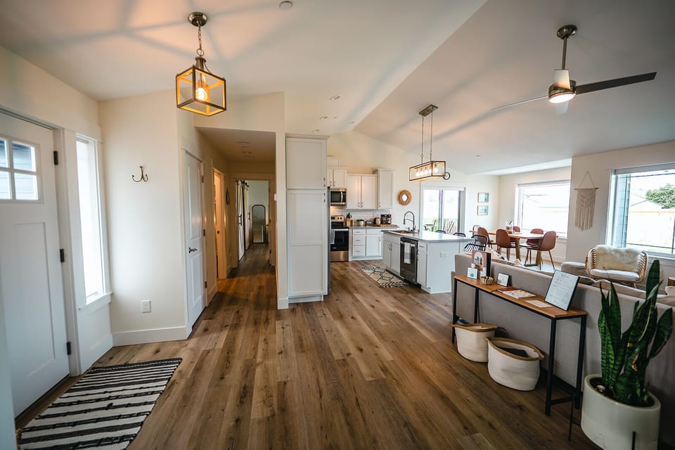 Entry, hallway to primary bedroom, kitchen, and living room 