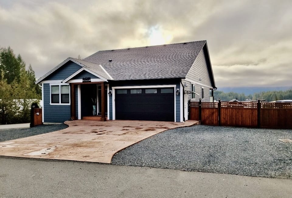 Front of the house with plenty of parking on the driveway and gravel area 