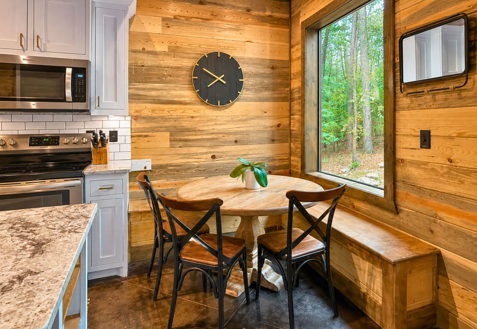 Enjoy your meals in this stylish dining area surrounded by natural wood and calming views.