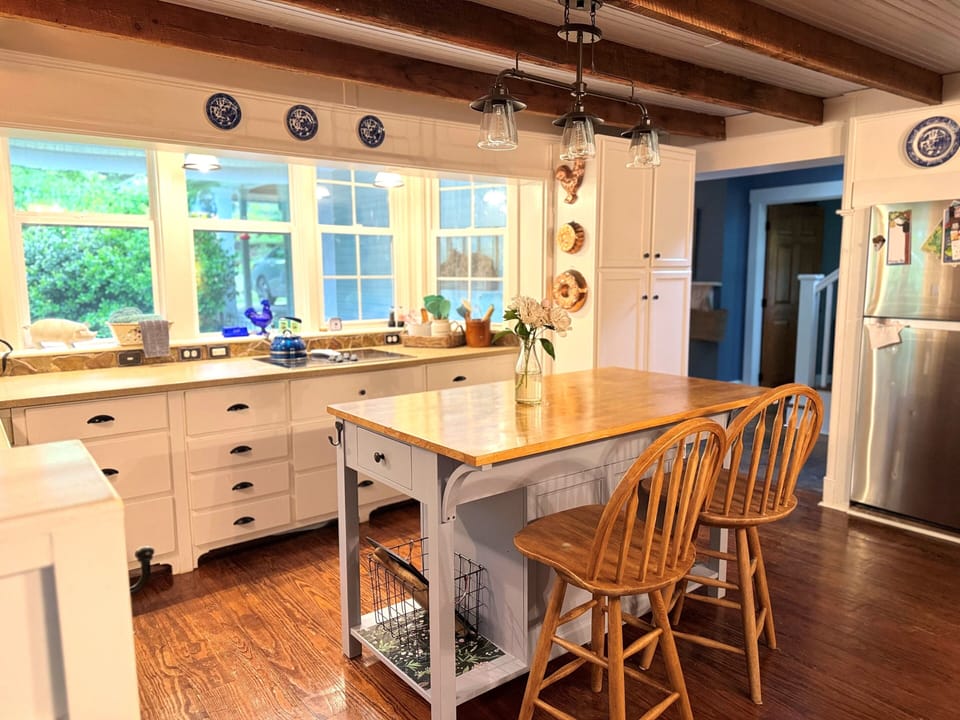 The cottage kitchen and island. We have cookware, bakeware and appliances.
