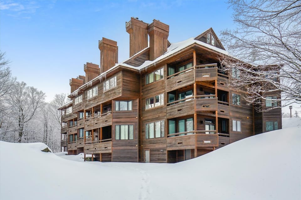 Inviting exterior with private entry and scenic winter surroundings.