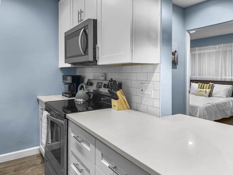 Kitchen with island, stainless appliances, and microwave in open-plan layout